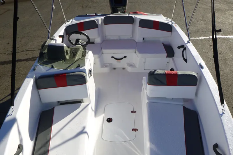 Slide: The Image of 2024 Tahoe T18 boat interior with seating, steering wheel, and storage compartments. - 15