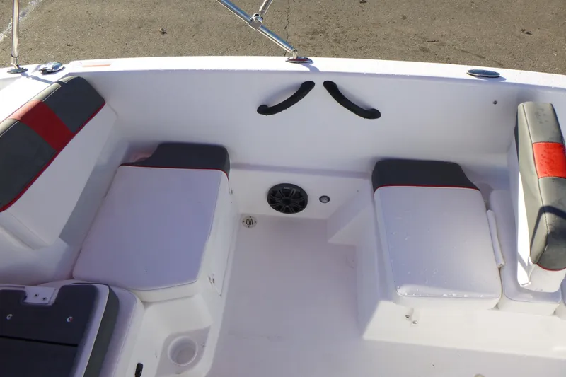 Slide: The Image of 2024 Tahoe T18 boat interior with cushioned seating and speaker system. - 16