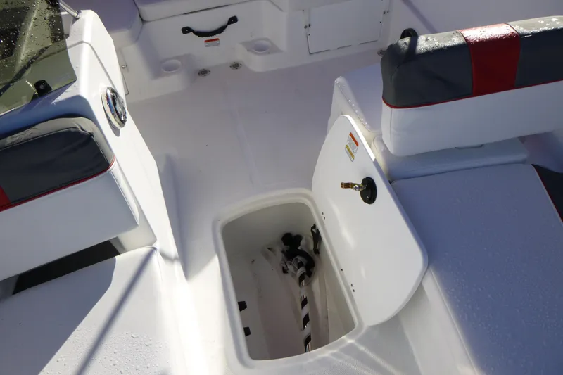 Slide: The Image of 2024 Tahoe T18 boat interior with open storage compartment and cushioned seating. - 18