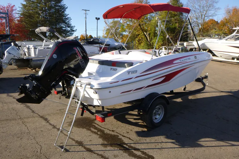 Slide: The Image of 2024 Tahoe T18 boat with red accents and outboard motor on trailer. - 5