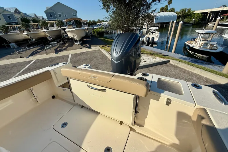 Slide: The Image of 2025 Scout 215 XSF boat interior with outboard motor at marina. - 6