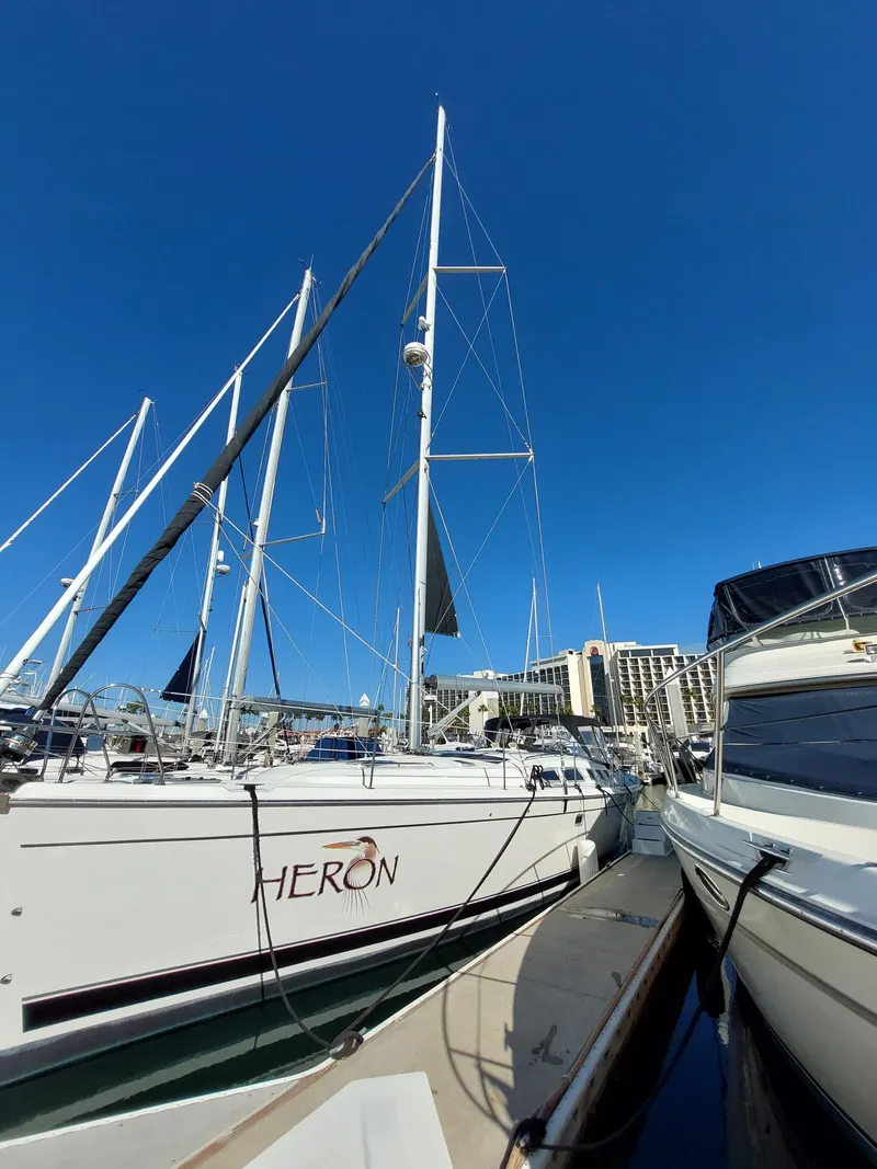 Slide: The Image of 2009 Hunter 49 sailboat docked at marina under clear blue sky. - 1