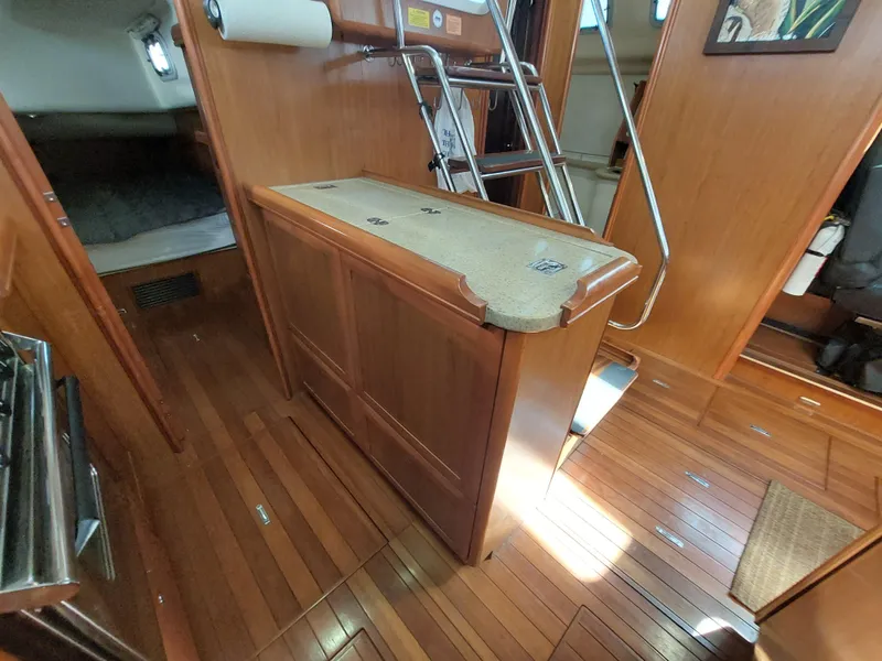 Slide: The Image of Interior of 2009 Hunter 49 sailboat with wooden flooring and cabinetry. - 19