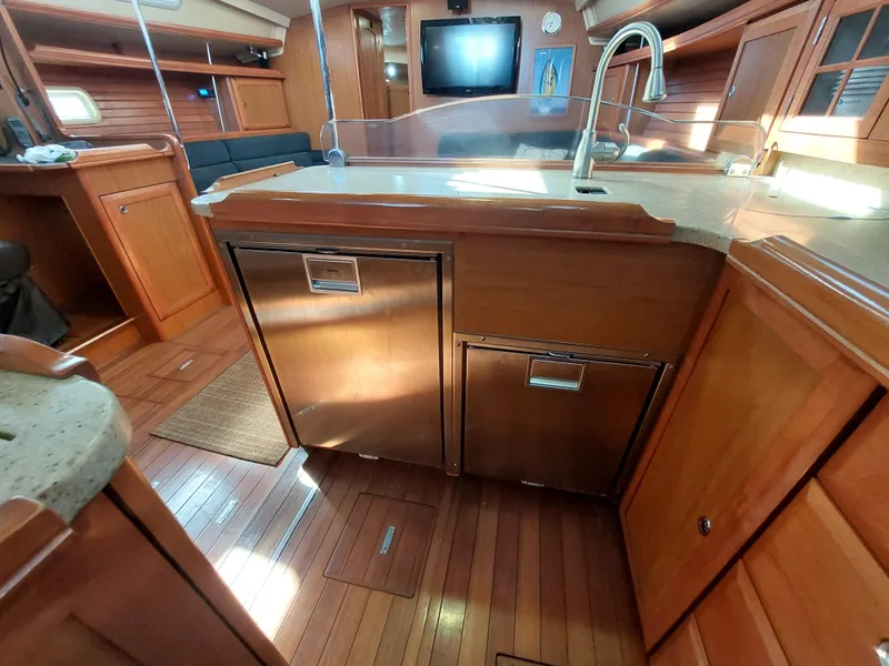 Slide: The Image of Interior of 2009 Hunter 49 yacht with wooden cabinetry and modern kitchen amenities. - 22