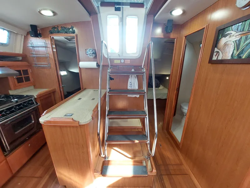 Slide: The Image of Interior of 2009 Hunter 49 yacht with wooden cabinetry and stainless steel stairs. - 25