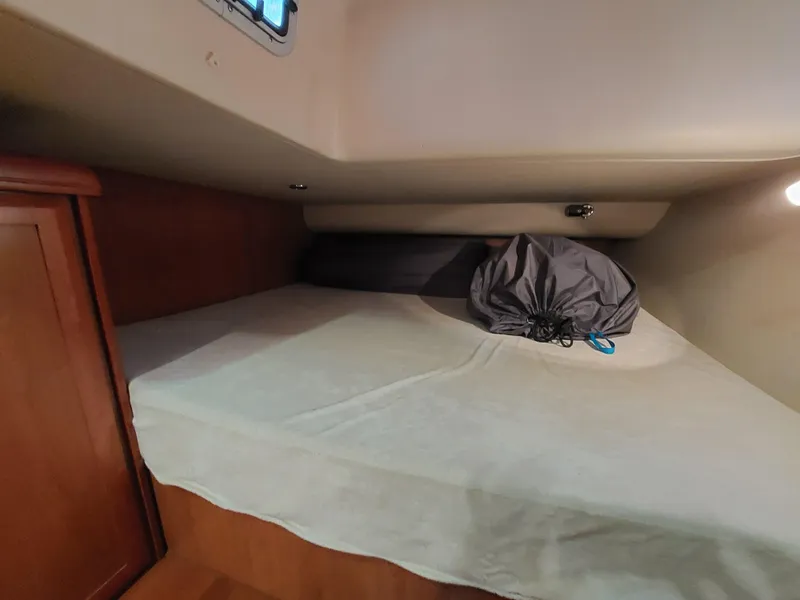 Slide: The Image of Cozy cabin interior of 2009 Hunter 49 sailboat with bed and storage. - 26
