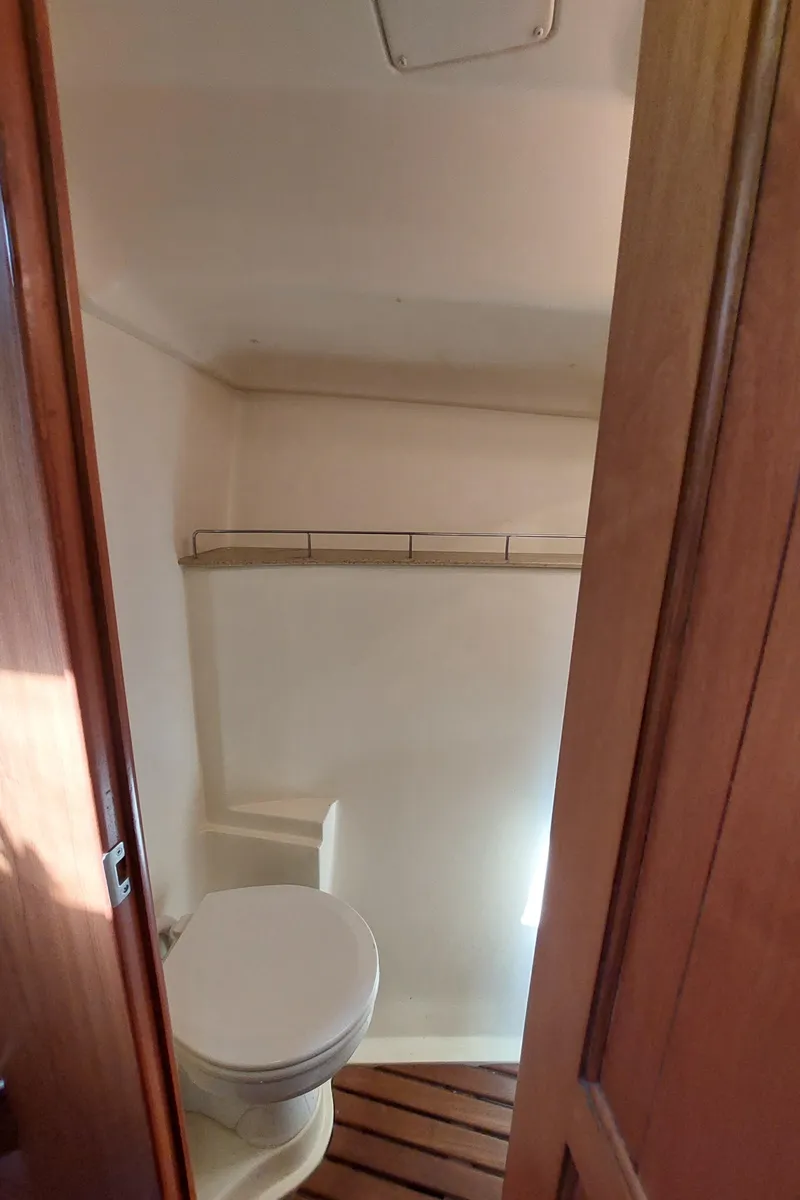 Slide: The Image of 2009 Hunter 49 yacht bathroom with wooden flooring and compact design. - 29