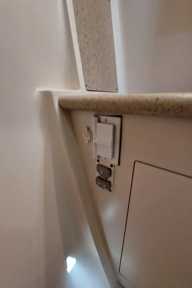Slide: The Image of Interior detail of a 2009 Hunter 49 yacht, featuring electrical outlets and cabinetry. - 31
