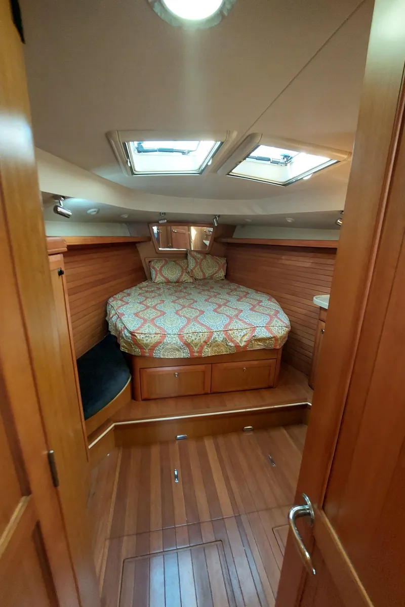 Slide: The Image of Cozy cabin interior of 2009 Hunter 49 sailboat with wood finish and skylights. - 32
