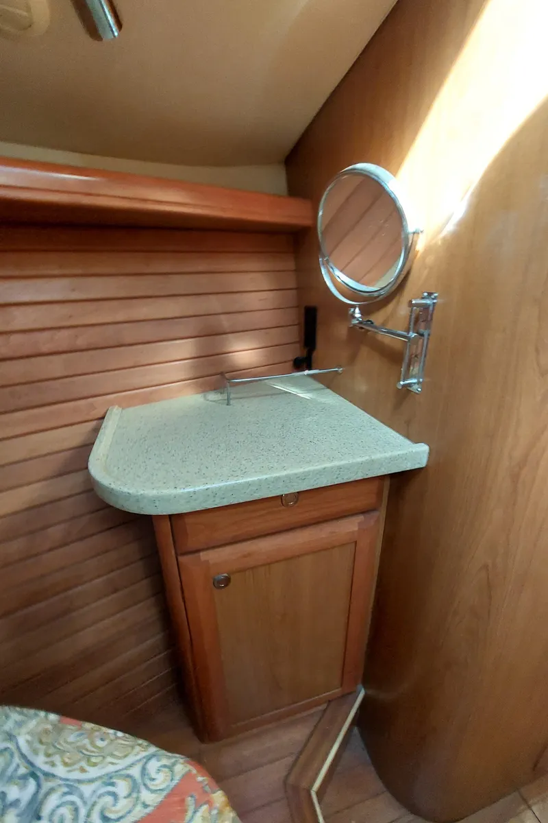 Slide: The Image of 2009 Hunter 49 yacht interior with wooden cabinetry and countertop. - 36