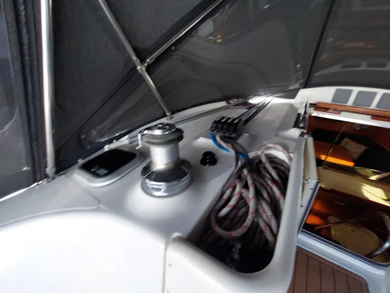 Slide: The Image of 2009 Hunter 49 yacht deck with winch and coiled ropes. - 44