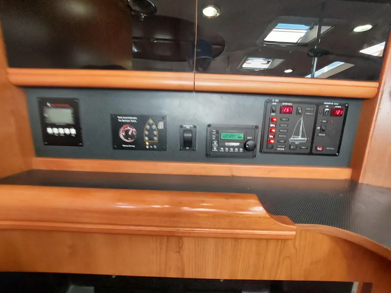 Slide: The Image of Control panel inside 2009 Hunter 49 yacht with various electronic displays and switches. - 7