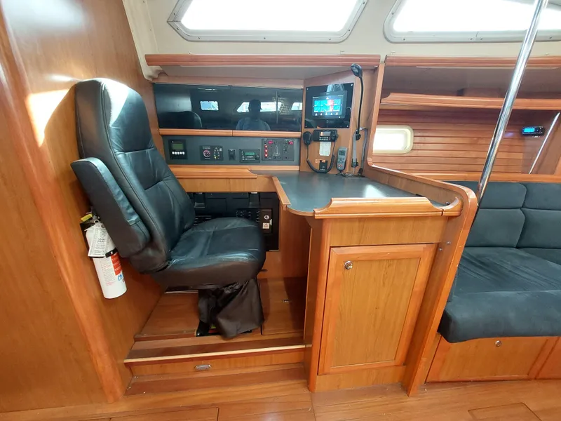 Slide: The Image of 2009 Hunter 49 yacht interior with navigation station and leather chair. - 9