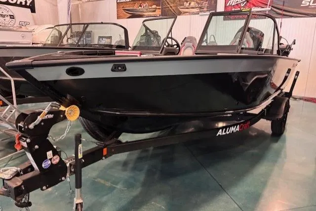 Slide: The Image of 2025 Alumacraft Trophy 185X Sport boat on trailer in showroom. - 0