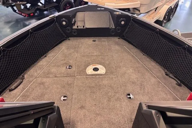 Slide: The Image of 2025 Alumacraft Trophy 185X Sport boat interior with carpeted deck and storage compartments. - 7