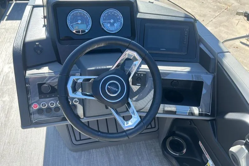 Slide: The Image of Steering console of 2025 Avalon Catalina Quad Lounger with modern controls and gauges. - 3