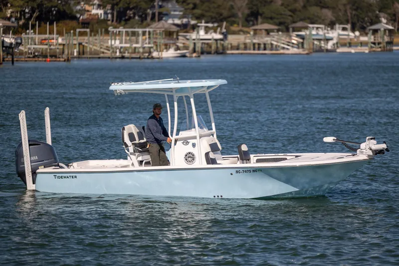 The Image of 2024 Tidewater 2300 Carolina Bay boat on water, featuring sleek design and Yamaha engine. - 1