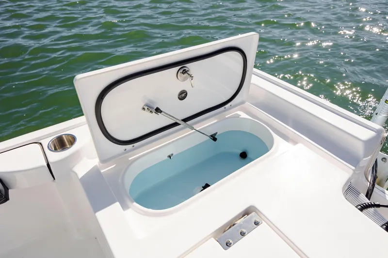 Slide: The Image of 2024 Tidewater 2300 Carolina Bay boat with open storage compartment on deck. - 10