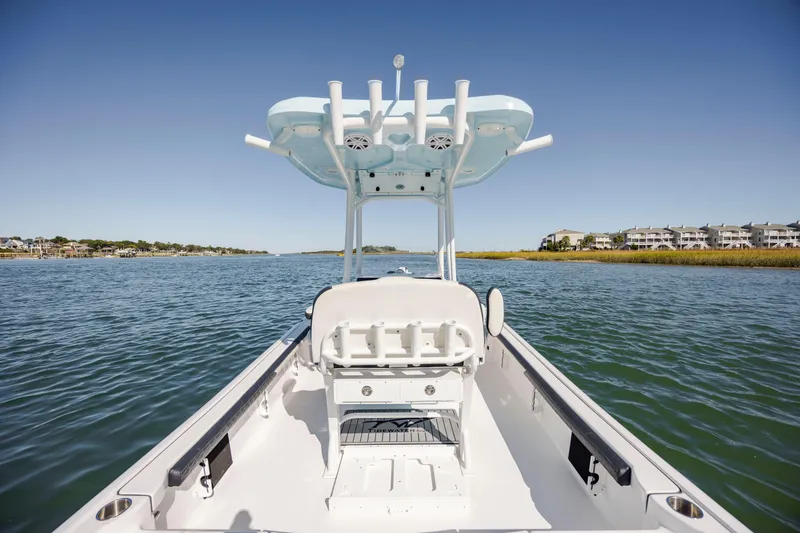 Slide: The Image of 2024 Tidewater 2300 Carolina Bay boat on calm water, clear sky background. - 11