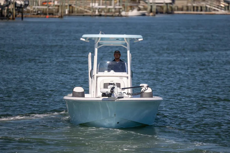 Slide: The Image of 2024 Tidewater 2300 Carolina Bay boat cruising on open water. - 2