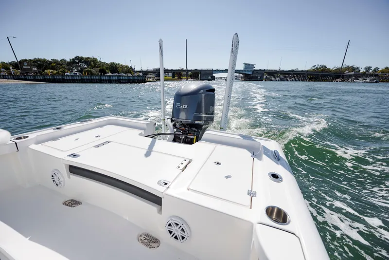Slide: The Image of 2024 Tidewater 2300 Carolina Bay boat cruising on open water, rear view. - 7