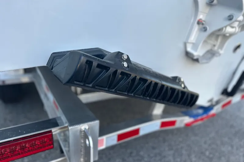 Slide: The Image of 2026 Cobia 285 Open Center Console boat detail with trailer, close-up view. - 11