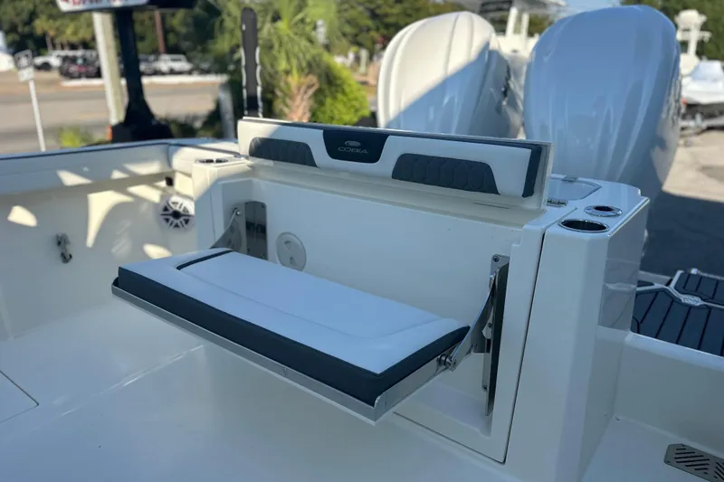 Slide: The Image of 2026 Cobia 285 Open Center Console boat with foldable seating and dual engines. - 12