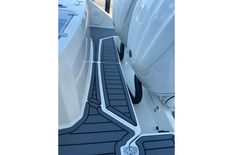 Slide: The Image of 2026 Cobia 285 Open Center Console boat deck with sleek design and modern features. - 13