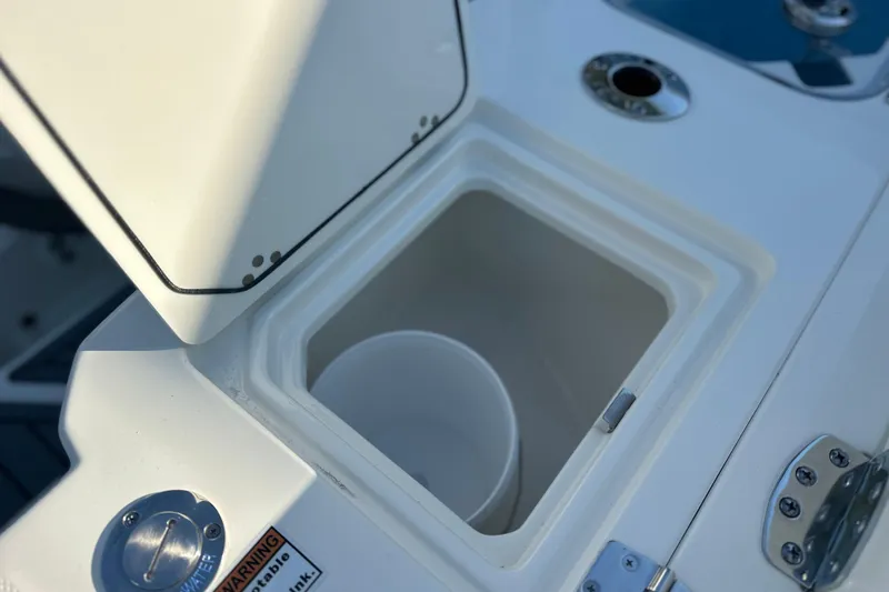 Slide: The Image of Open storage compartment on 2026 Cobia 285 Open Center Console boat. - 17
