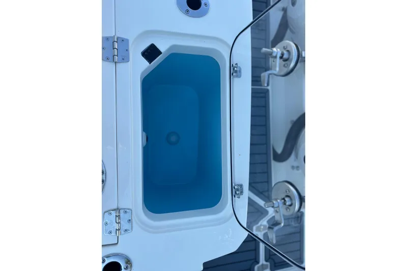 Slide: The Image of 2026 Cobia 285 Open Center Console boat's storage compartment detail. - 18