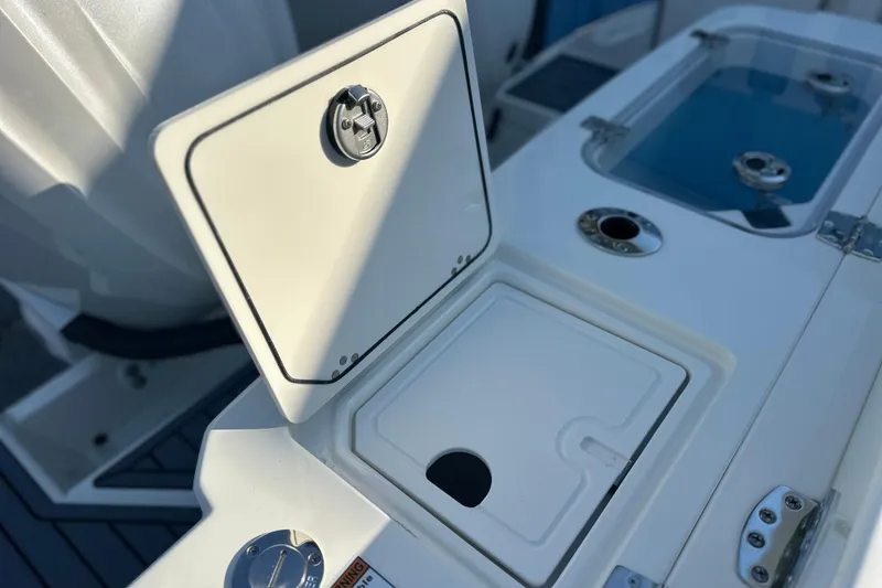 Slide: The Image of 2026 Cobia 285 Open Center Console boat deck with storage compartments. - 19