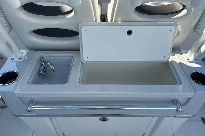 Slide: The Image of 2026 Cobia 285 Open Center Console boat sink and storage area. - 21