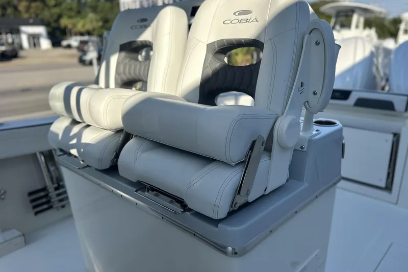 Slide: The Image of 2026 Cobia 285 Open Center Console boat seats, featuring luxurious white upholstery. - 23
