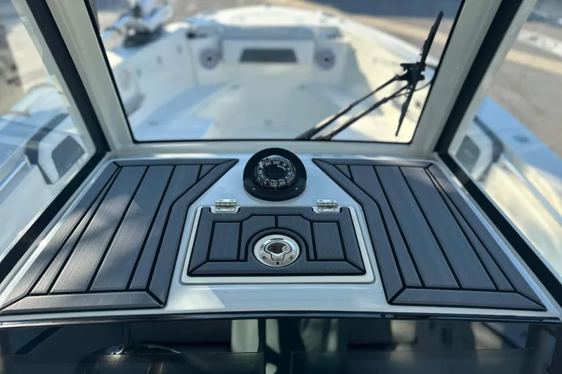 Slide: The Image of 2026 Cobia 285 Open Center Console dashboard with compass and sleek design. - 33