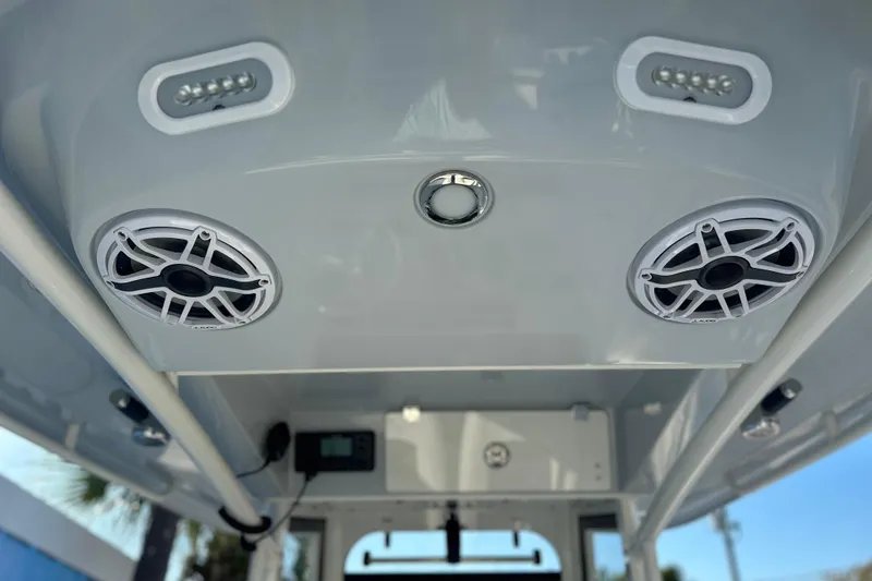 Slide: The Image of 2026 Cobia 285 Open Center Console boat speakers and lights on the ceiling. - 34