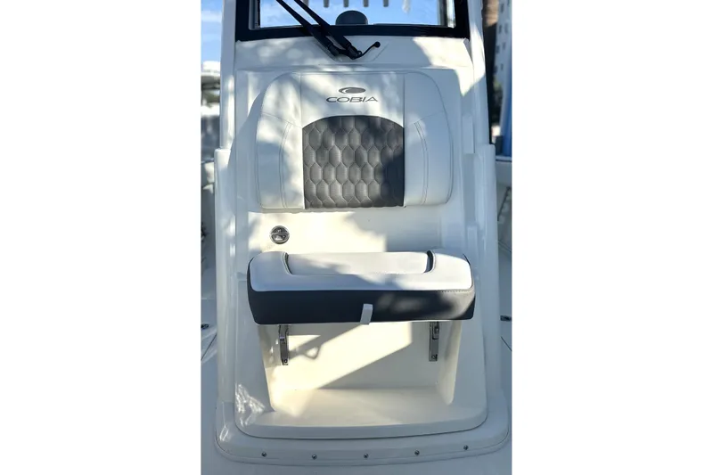 Slide: The Image of 2026 Cobia 285 Open Center Console boat seat with cushioned backrest. - 38