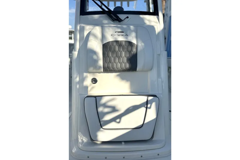 Slide: The Image of 2026 Cobia 285 Open Center Console boat seat with logo and storage compartment. - 39