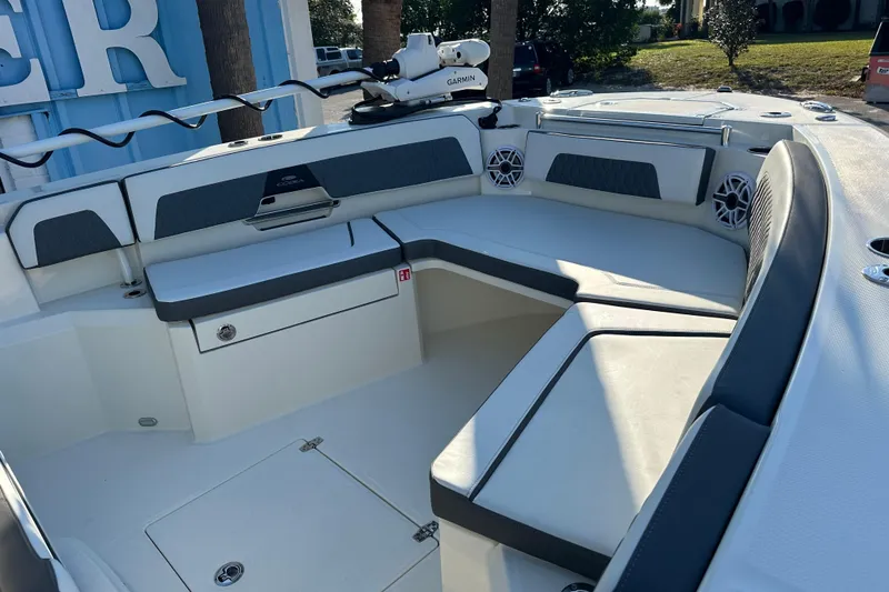 Slide: The Image of 2026 Cobia 285 Open Center Console boat interior with cushioned seating and storage. - 41