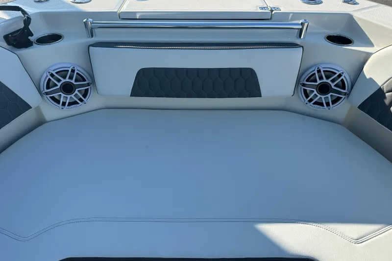 Slide: The Image of 2026 Cobia 285 Open Center Console boat interior with speakers and seating area. - 42