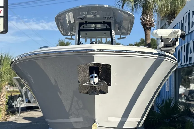 Slide: The Image of 2026 Cobia 285 Open Center Console boat, front view, outdoors with palm trees. - 7