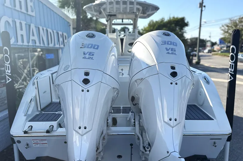 Slide: The Image of 2026 Cobia 285 Open Center Console with twin 300 V6 engines, rear view. - 9