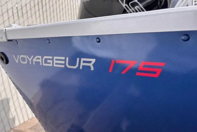 Slide: The Image of 2024 Alumacraft Voyageur 175 Sport boat, blue exterior with red model lettering. - 2