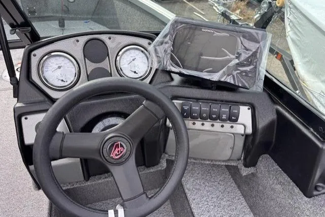 Slide: The Image of 2024 Alumacraft Voyageur 175 Sport dashboard with steering wheel and Garmin navigation system. - 6