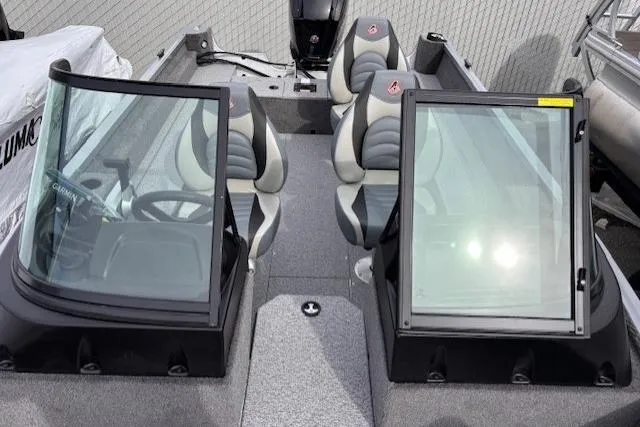 Slide: The Image of 2024 Alumacraft Voyageur 175 Sport boat interior with dual windshields and seating. - 9
