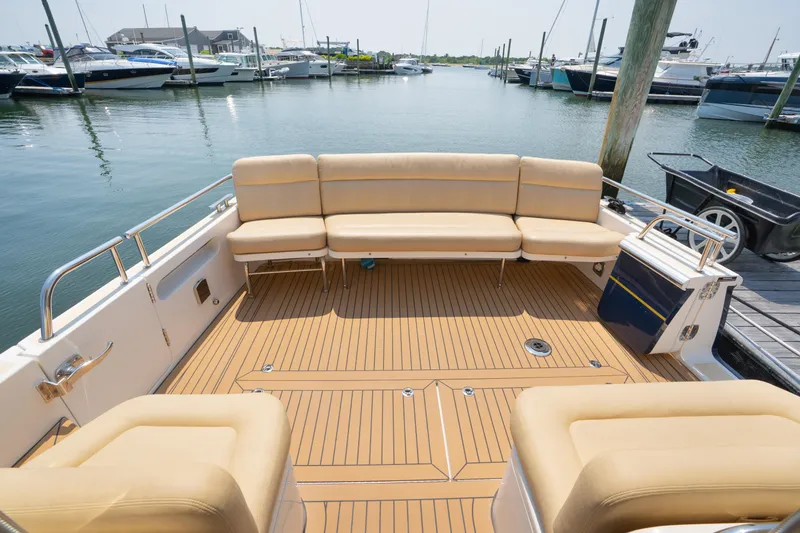 Slide: The Image of Interior of 2017 MJM 40z Downeast yacht with helm, seating, and marina view. - 17