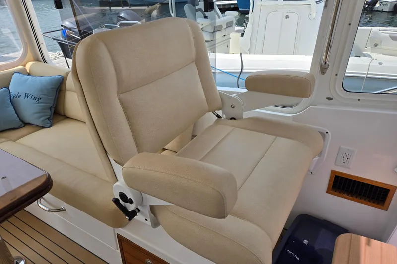 Slide: The Image of Luxurious interior seating of 2017 MJM 40z Downeast boat with beige upholstery. - 23