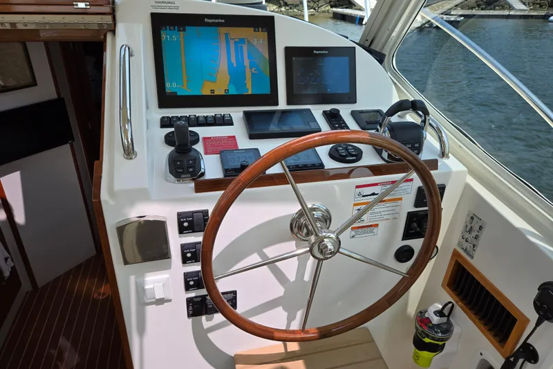 Slide: The Image of Helm of 2017 MJM 40z Downeast boat with navigation equipment and wooden steering wheel. - 25