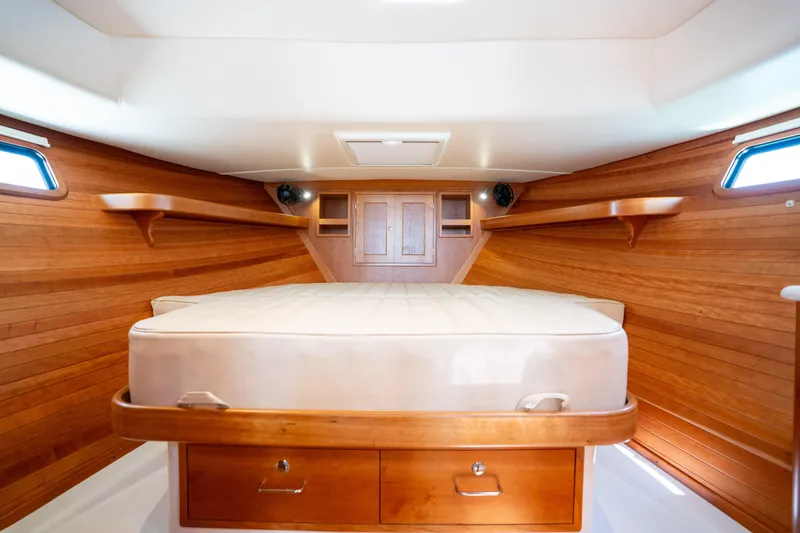 Slide: The Image of 2017 MJM 40z Downeast cabin interior with wooden walls and bed. - 32