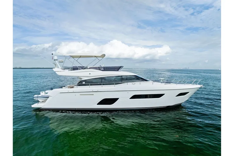 The Image of 2018 Ferretti Yachts 550 cruising on calm ocean waters under a cloudy sky. - 0