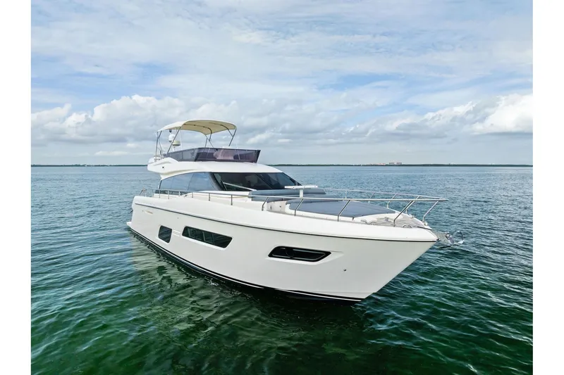 Slide: The Image of 2018 Ferretti Yachts 550 on calm green waters, aerial view. - 2